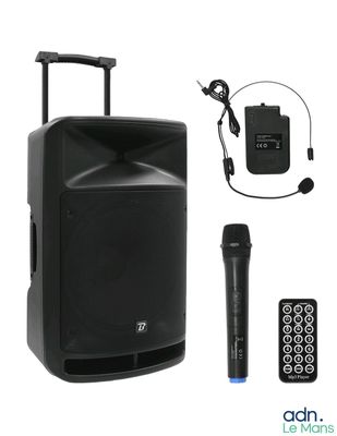a close up of a speaker with a microphone and a remote