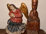 a statue of an angel and a statue of a man on a table