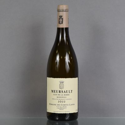 a bottle of wine sitting on top of a glass table
