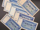 five old blue and white notes are stacked on top of each other