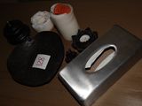 a metal box with a handle and some other items on a table