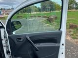 a white car with the door open on the side of the road