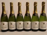 six bottles of champagne are lined up on a table