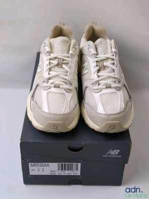 a pair of new balance shoes in a box on a table