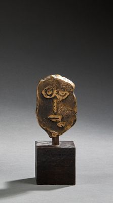 bronze head of a man on a wooden stand