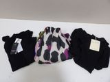 three pairs of women ' s leggings, one black and one white