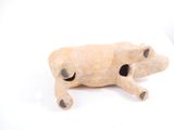 a figurine of a dog laying down on a white surface