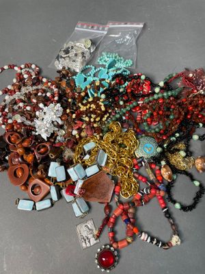 a pile of assorted necklaces and bracelets on a table
