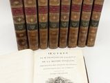 several old books sitting on top of each other next to a book