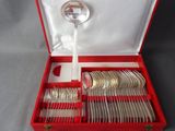 a red box with silverware in it on a table