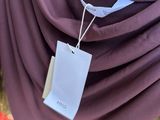 a close up of a woman ' s shirt with a tag attached to it