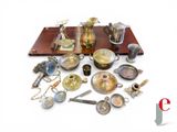 a lot of silver and brass items on a table