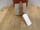 a small bag with a tag on it sitting on a table