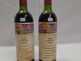 two bottles of wine sitting next to each other on a table