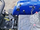 a close up of a blue tractor with a plastic cover on it