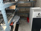 a refrigerator in the middle of a room with shelves and shelves