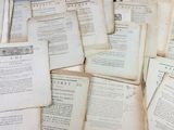 a pile of old books sitting on top of a table