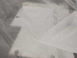 a sheet of plastic covering a bed with a laptop on it