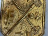 a gold plate with a picture of a train on it