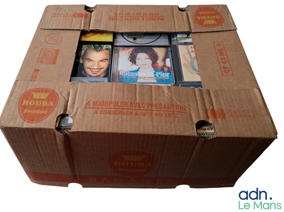 a cardboard box with a bunch of dvds inside of it