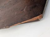 a piece of wood on the wall that has writing on it