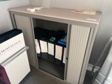 an image of a small bathroom with a sink and a cabinet