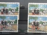 two stamps with a picture of a man and a woman on a horse drawn carriage