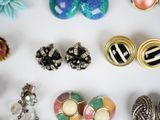 many different types of jewelry on a white surface