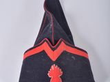 a black and red hat with a red bird on it