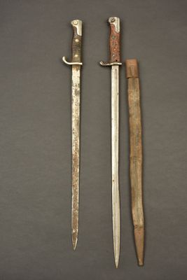 two knives are sitting next to each other on a table
