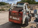 a forklift that is parked in the dirt