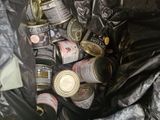 many cans and cans of food in a trash can