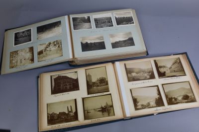 two open books with pictures of buildings on them sitting on a table