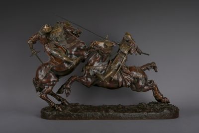 statue of a man riding a horse with a spear on his back