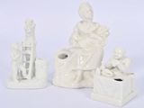 a white figurine of a woman and a child