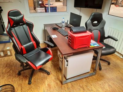 a desk with two chairs and a computer on top of it