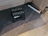 a remote control sitting on the floor next to a cabinet