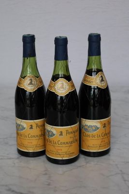 three bottles of wine are lined up on a marble surface