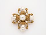 an image of a gold and pearl broochle on a white background