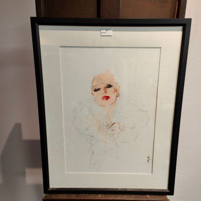 a drawing of a woman ' s face is shown in a black frame