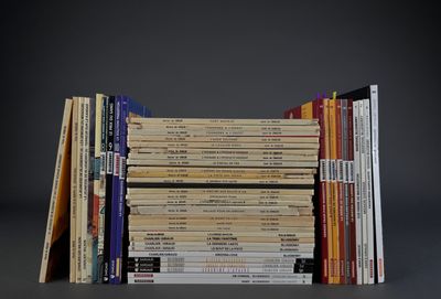 several books stacked on top of each other on a table