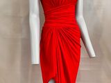 the mannequin is wearing a red dress and a necklace