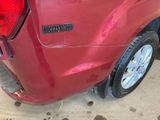 a close up of a red truck with a sticker on it ' s side