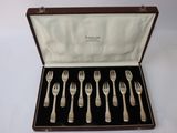 six forks and a spoon in a wooden case