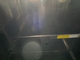 a black oven with a door open in a kitchen