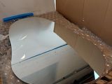 a mirror sitting on a cardboard box in the middle of a room