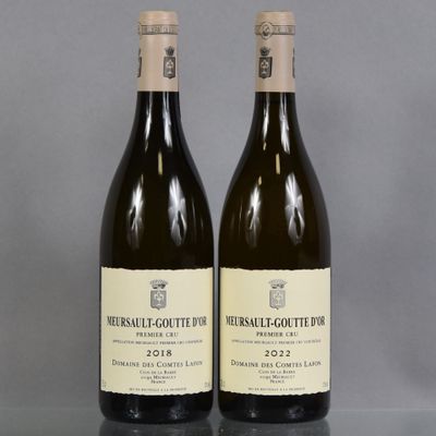 two bottles of wine sitting on top of a table next to each other