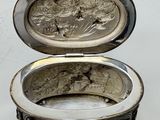 an image of a silver box with a picture of a man and a woman on it