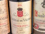 several bottles of wine are lined up on a table