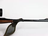 a close up of a rifle on a white background with a scope